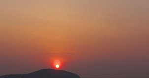 Time lapse footage of the sun in beautiful sunset over mountain. High-quality free stock video footage of time lapse or timelapse of the large orange sunset into the horizon above. Dramatic sunset sky