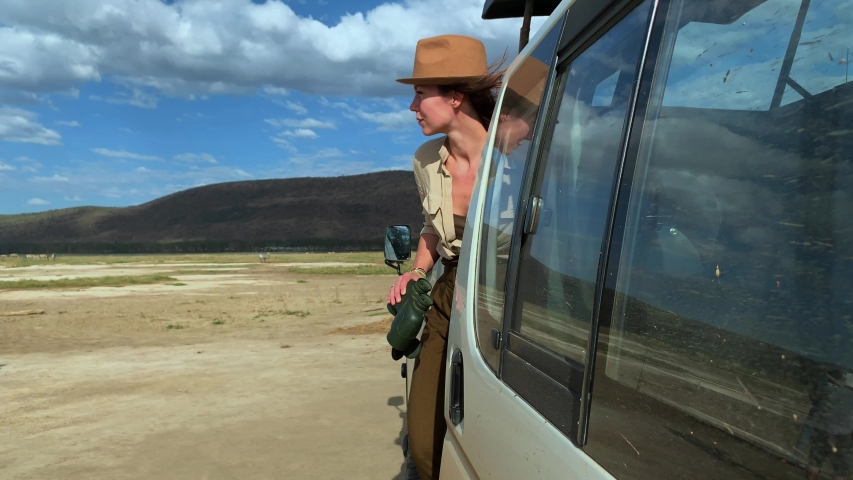 Woman on a safari trip in Masai Mara park, Kenya
