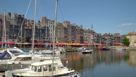 HONFLEUR, FRANCE - JUNE 2018: Panoramic view of Honfleur harbour old port with beautiful houses and lots of yachts. Honfleur is located in the northern region of Calvados, Normandy, France.