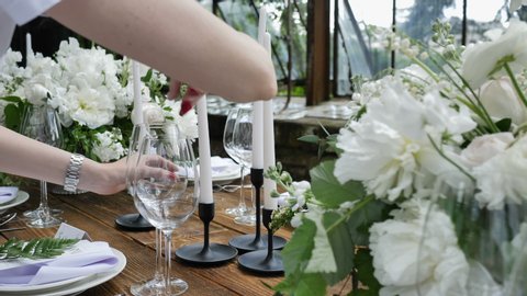 Decorating a Festive table. Wedding Table Decoration with Bouquets of Natural Fresh Flowers for a Family Feast