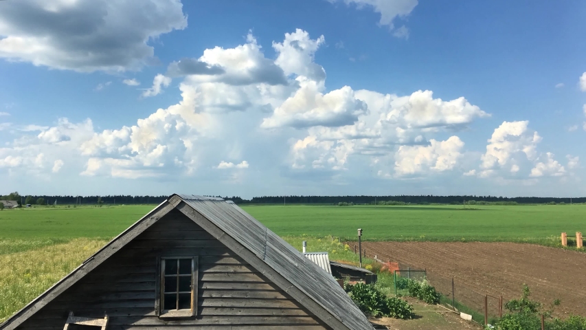 clouds move quickly over the old barn on a summer day timelapse video