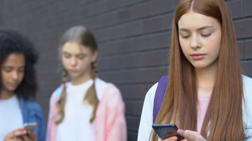 Teen girl upset by shameful video in internet, classmates mocking, cyberbullying | Shutterstock HD Video #1033504646