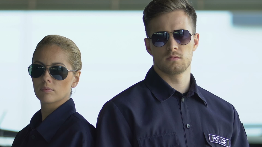 Brave police officers in sunglasses posing on camera, district patrol, security