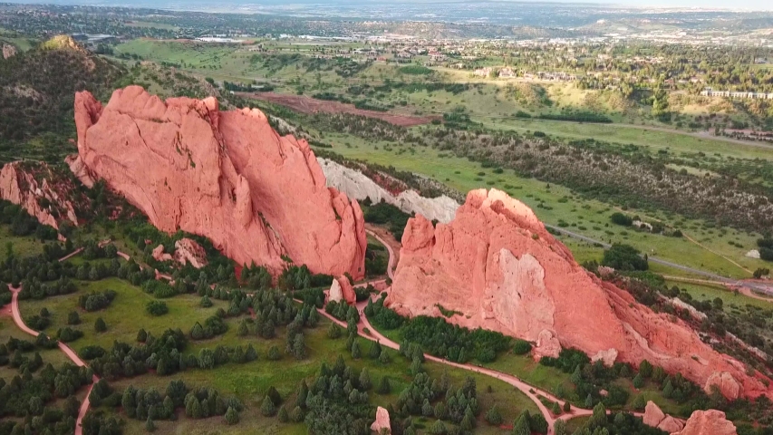 Aerial, tilt down, drone shot, overlooking sandstone formations and the park, at the Garden of the Gods, sunset, on a sunny evening, in Colorado springs, USA