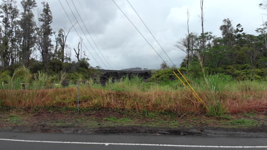 Drone Flying through Telephone Cables Revealing Lava Field in Kapoho, Hawaii.