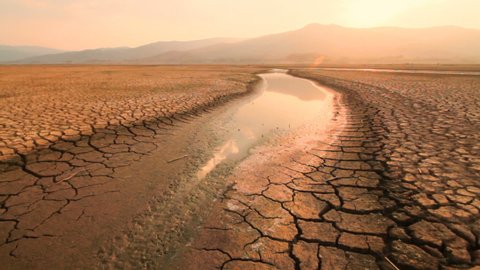 Extreme weather change the river to desert. Climate change impact, the water drying and turned to landscape of cracked earth