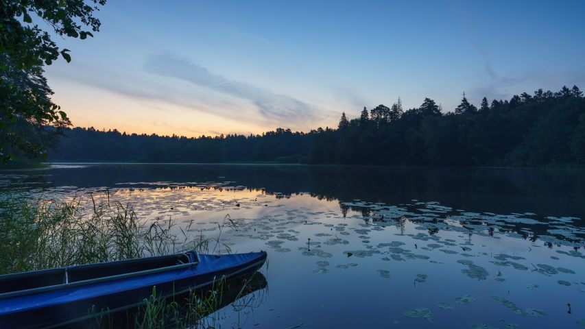 Timelapse of beautiful calm sunrise on a forest lake