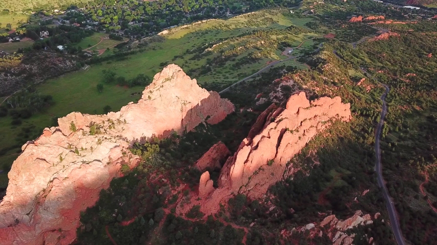 Aerial, tracking, drone shot, overlooking the famous sandstone formations, at the Garden of the Gods, at sunset, on a sunny evening, in Colorado springs, USA