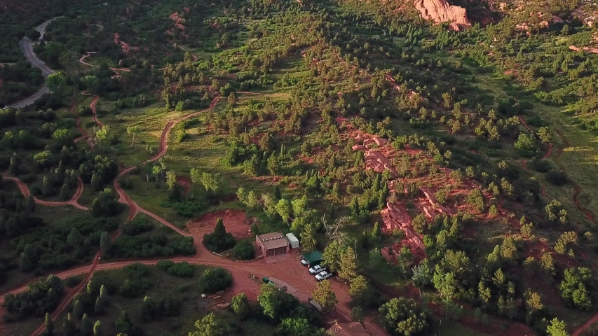 Aerial, tilt up, drone shot, over the at the Garden of the Gods park, revealing red sandstone mountains, on a sunny evening, in Colorado springs, USA