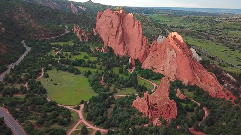Aerial, tracking, drone shot, panning around sandstone mountains, at the Garden of the Gods, on a sunny evening, in Colorado springs, USA