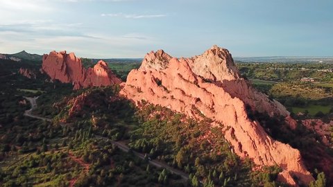 Aerial, rising, drone shot, towards the famous sandstone mountains, at the Garden of the Gods, on a sunny evening, in Colorado springs, USA
