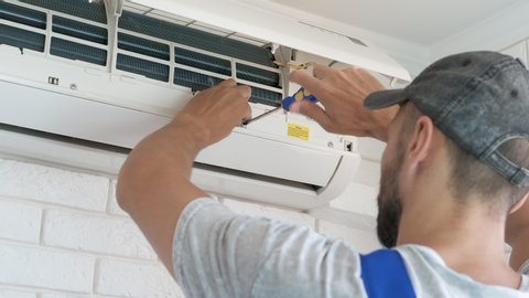 Air conditioning repair. A man repairs air conditioning.