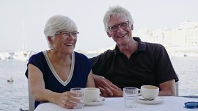 Retired couple enjoying coffee on a resort - Powered by Shutterstock - Get 15% off with code: PIKWIZARD15