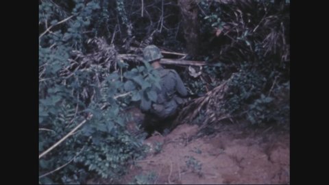 CIRCA 1970 - American soldiers uncover Viet Cong booby traps in the jungle.