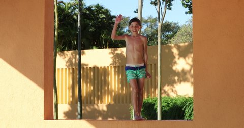 Goofy Little boy dancing at the pool setting
