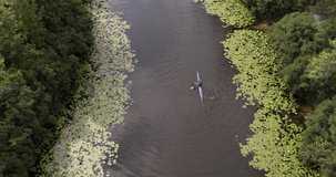 Man Rowing in Kayak on river Aerial Top view water sport Wide shot 4K video