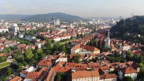 Aerial view of Ljubljana, Slovenia. Fly over Ljubljanica river and old town. Drone video, sunny summer morning