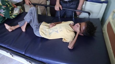 Yemeni boy his name Ghazi Ali bin Ali, 10, suffering from severe malnutrition lies on a bed at a  " ALMODHFAR " hospital   on  city of Taiz, on October 30, 2018 . The war has left almost 10,000 people