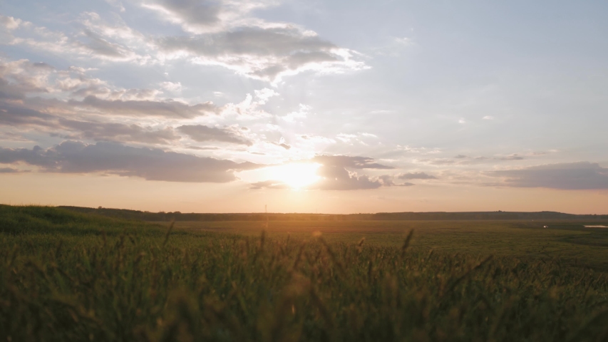The Silhouette of two man on the top of mountain with Backpacks and other Gear expressing Energy and Happiness. Two tourist young men on rocky cliff and enjoying view. Travel concept.