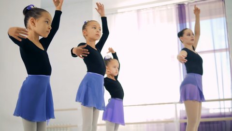 Young ballerinas training in a class, close up.