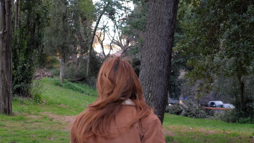 desperate lonely red haired youg woman in the park,looking up