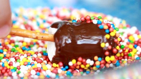 Homemade Lollipop Popcake Marshmallows Candy in Black Chocolate With Colored Cake Mate Sprinkles Rainbow Dressing.