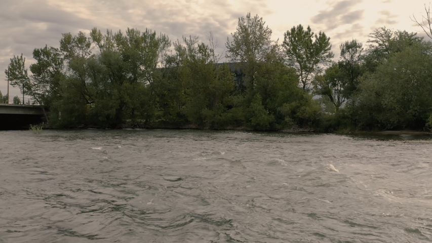 Aerial drone shot pan up from Boise River to reveal downtown Boise.