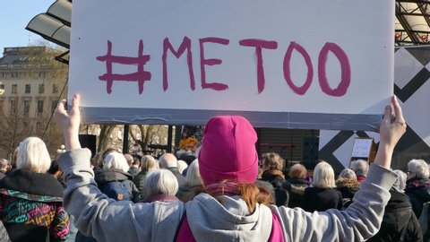 Stockholm, Sweden, Nov 2018: Rear back shot of a girl holding a #MeToo sign during demonstrations in Sweden