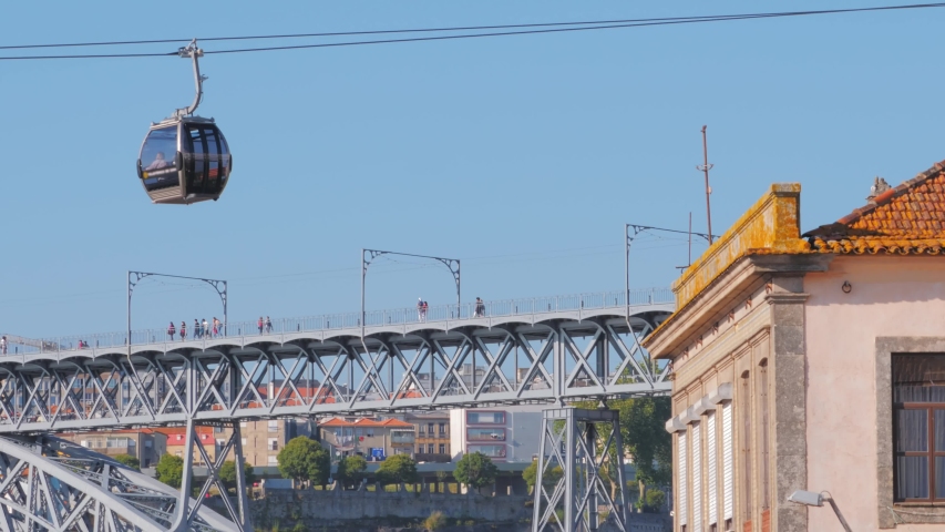 Metro train Dom Luis bridge and cable car in Vila Nova de Gaia Porto city in the background, Portugal