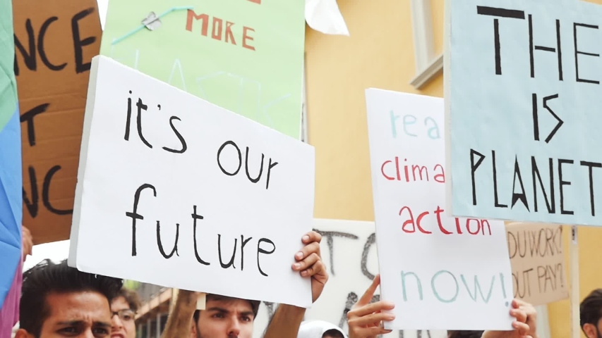 Public demonstration on the street against global warming and pollution. Group of multiethnic people making protest about climate change and plastic problems in the oceans Royalty-Free Stock Footage #1033661714