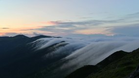 Amazing evening flowing fog in mountains. Timelapse of beautiful nature of Ukrainian Carpathians. UHD 4K video