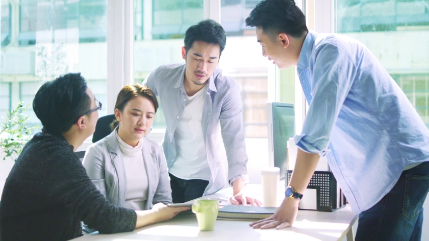 group of four young asian business people men and woman meeting discussing in office Royalty-Free Stock Footage #1033672841