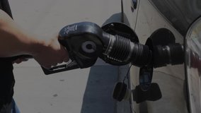 This closeup video shows someone finishing pumping gas and then putting a gas cap back on their car.