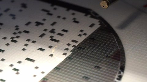 Slow motion video of Close up pick up silicon die in silicon wafer