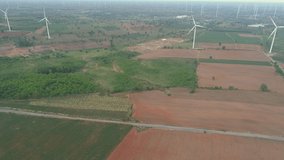Aerial view of Wind turbines of save Energy save world in video 4k format. aerial shot on sunset. drone footage turbines at sunrise with beautiful clouds