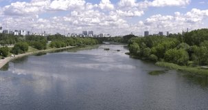 4K bright summer day high quality video footage of Grebnoi rowing water sports channel, bridges, stadiums, white clouds sky in suburb Krilatskoye, Moscow River watercourse in Moscow, Russia