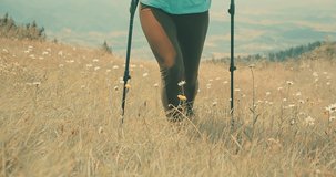 Happiness Woman tourist traveler walking on the top of mountain meadow in summer, sunny day under sun light. 4K slow motion video