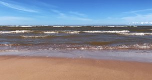Baltic sea waves crashing on sandy beach, 4K.