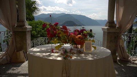 Lake Como in Italy. Cinematic look, decorations and flowers at the wedding dinner. Luxury wedding. Registration of a wedding banquet.