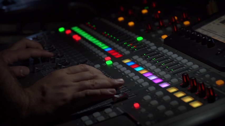 Professional tool sound engineer in the studio or at a concert. Musical digital mixer to adjust the scene close-up. The hands of man. Music and live sound. | Shutterstock HD Video #1033716722