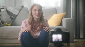 Woman famous blogger is recording video for her online vlog using camera