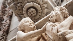 Beautiful Duomo di Milano in close up. White marble stone sculptures and statues in exterior design of ancient catholic church in center of Milan city in Italy. Gothic architecture style in details