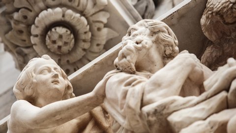 Beautiful Duomo di Milano in close up.White marble stone sculptures and statues in exterior design of ancient catholic church in center of Milan city in Italy.Gothic architecture style in details