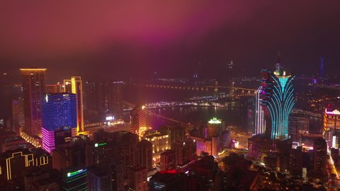 MACAU, CHINA - FEBRUARY 10 2019: night time illumination flight over macau city famous hotel area bay aerial panorama 4k circa february 10 2019 macau, china.