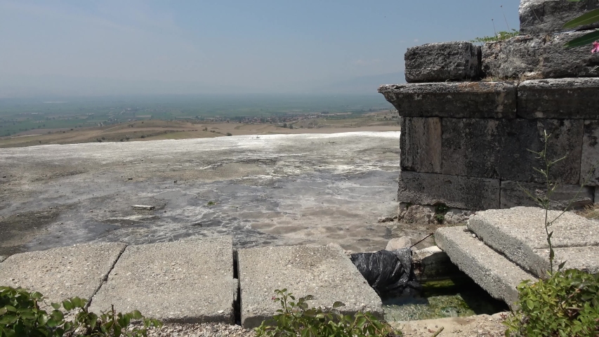Pamukkale, Denizli, Turkey - 16th of July 2019: 4K Water system and a tomb on terrace above the valley
