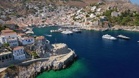 Aerial birds eye view video taken by drone of picturesque port entrance memorial in island of Hydra or Ydra, Saronic gulf, Greece