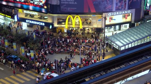 Kuala Lumpur, Malaysia - 20/7/2019 : Night scene at the Bukit Bintang in Kuala Lumpur, while a group of buskers performs in front of a McDonalds outlet near LRT station
