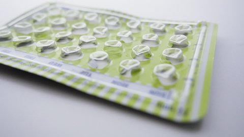 Empty package of birth control pills drops. Oral contraceptives prevent unwanted pregnancy and are the lynchpin of women's reproductive rights.