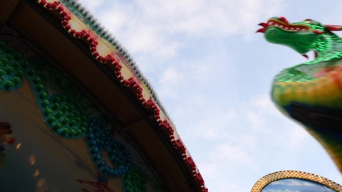 Bottom view under move and swing of Green Dragon Pirate Ship Ride with angular movement. Famous amusement ride for carnival, fun fair. 