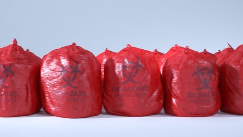 Loopable animation of the red bags with the medical waste inside. Hospital garbage with contaminated, infectious rubbish. Seamless shot of the biological trash on the white background.
